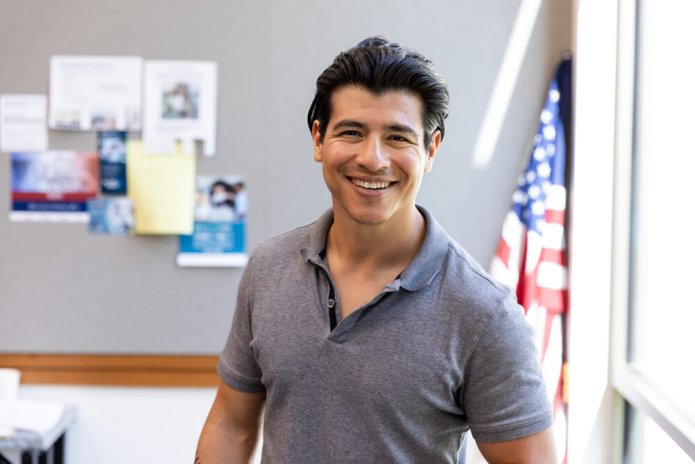 man in business casual shirt smiling